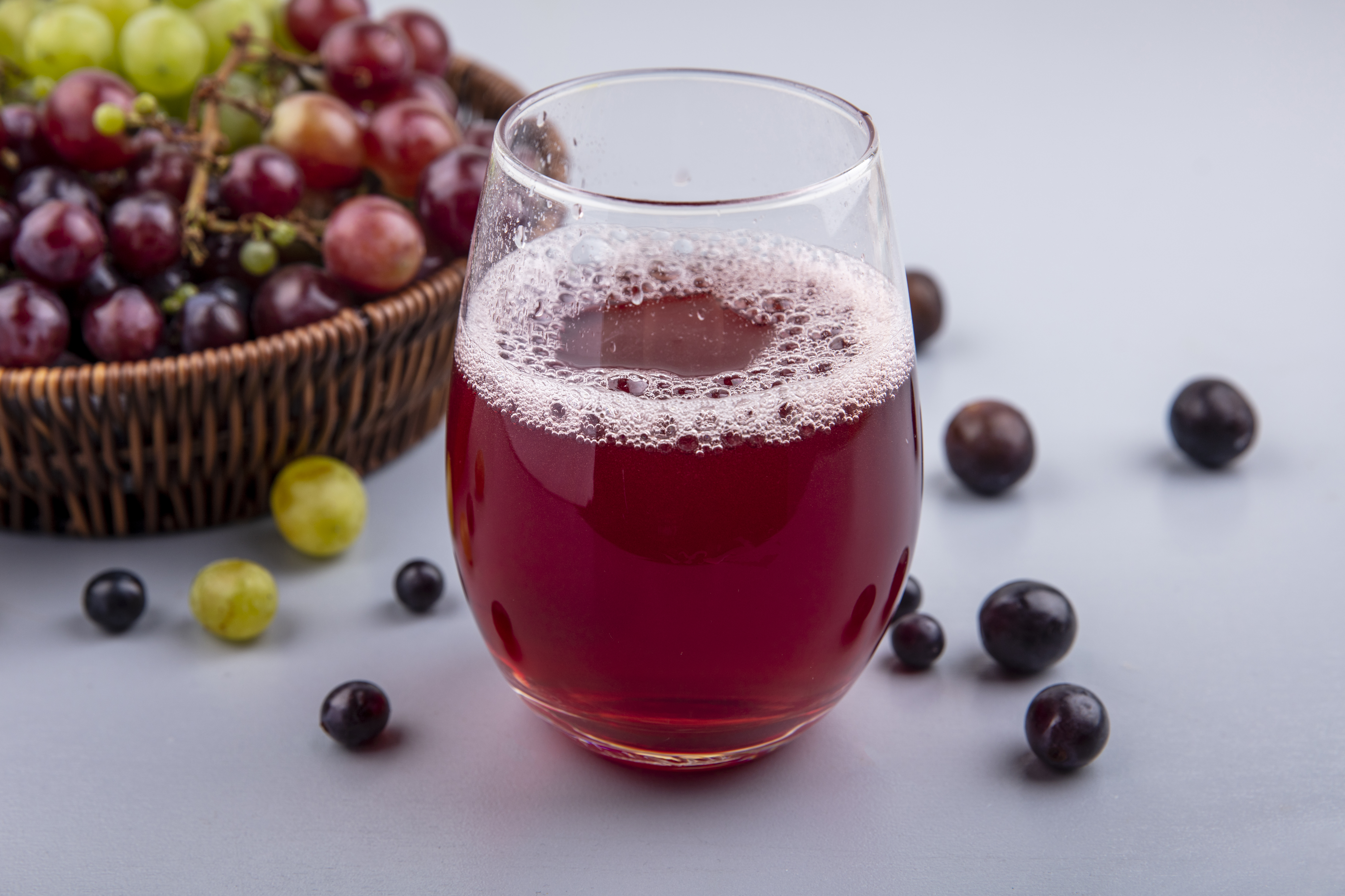 Purple grape juice in a glass with a digestive health theme
