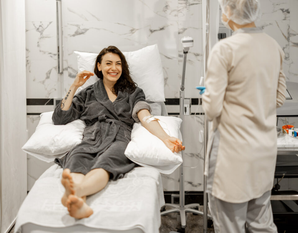 Nurse administering infusion therapy in GI clinic