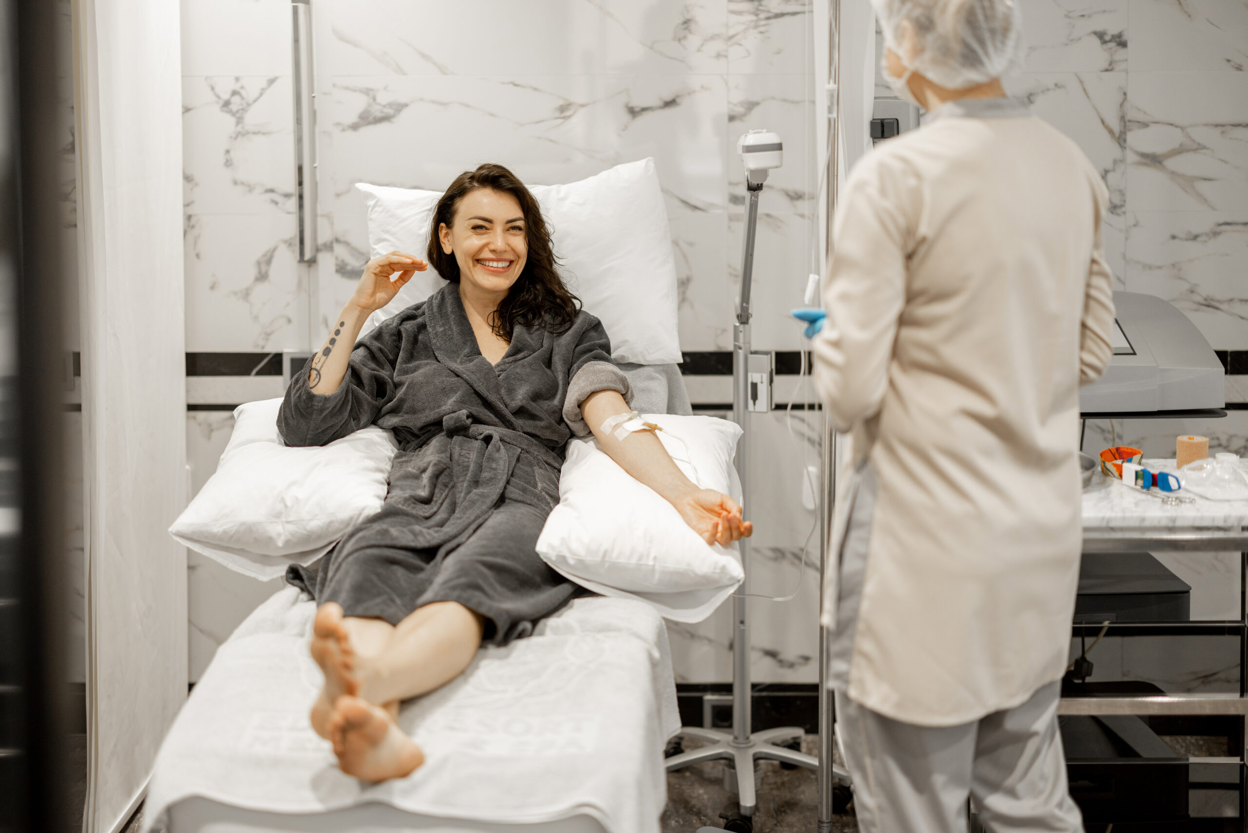 Nurse administering infusion therapy in GI clinic