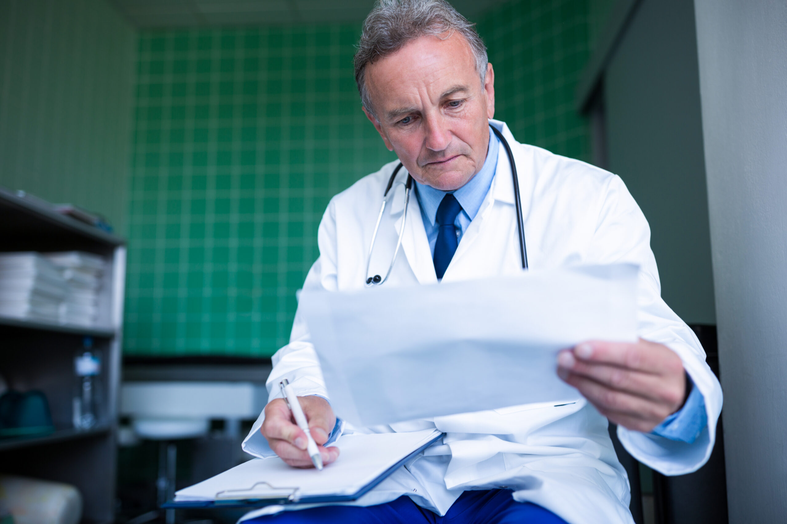 Board-certified gastroenterologist reviewing patient records