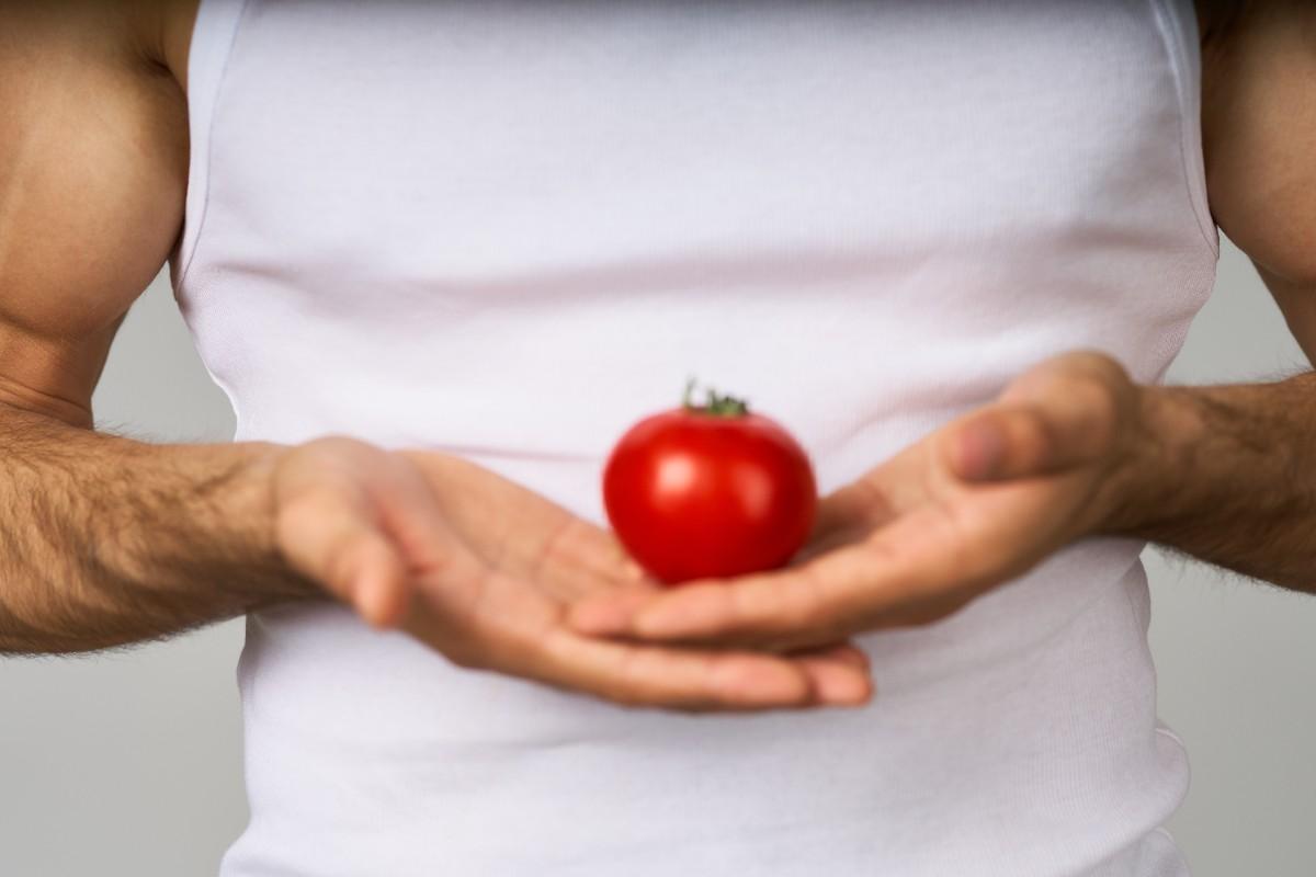 Halved tomato with esophagus and stomach diagram illustrating acid reflux triggers