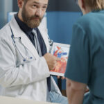 Diagram showing stages of colon cancer and early detection through screening colonoscopy